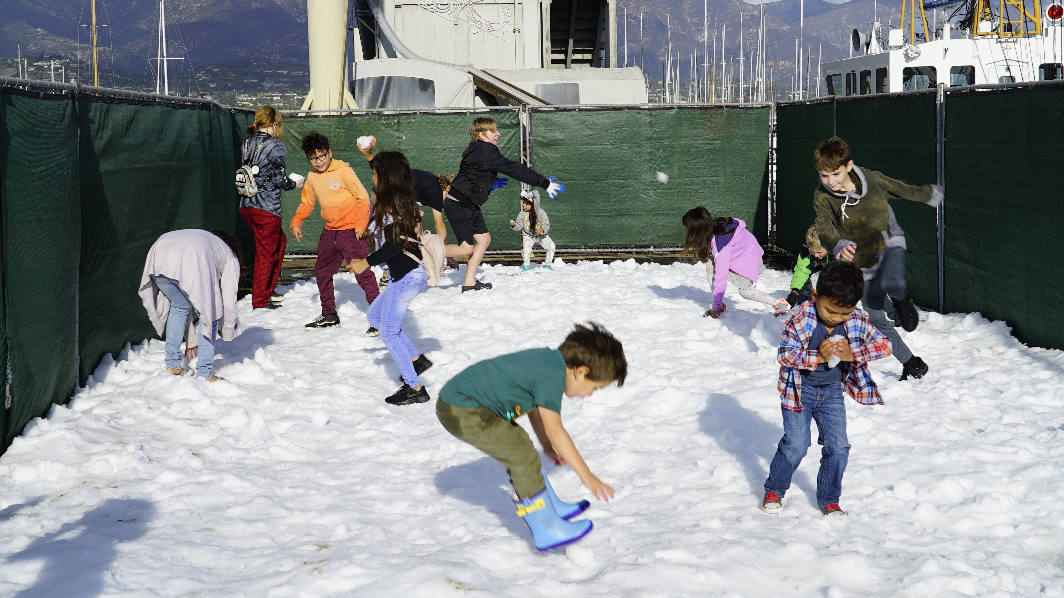 Kids play on snow pile