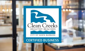 Certified Clean Creeks Business logo with storefront in the background