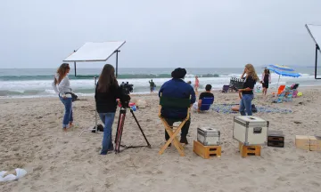Creeks and City TV staff film a television ad at the beach