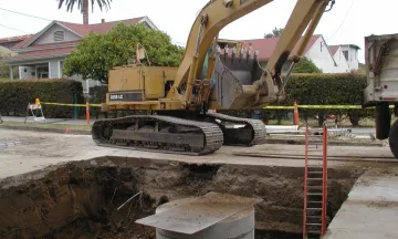 Heavy equipment in street installing Haley Street CDS (continuous deflection system) unit