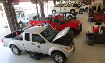 Overhead view of the Fleet Bay with two cars being serviced. 