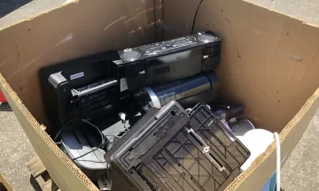 Box filled with an old printer, boombox, monitor to be recycled