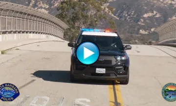 This image shows a police vehicle with lights on in motion to demonstrate the new siren