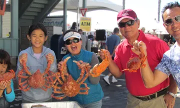 Family holding various crabs
