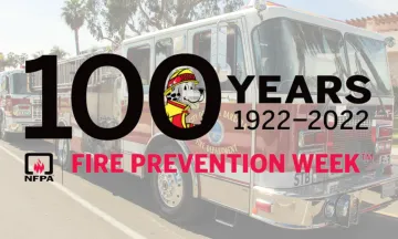 This image is a graphic to mark Fire Prevention Week, it reads, "100 years,  1922-2022" with Sparky the Dog. The background features a Santa Barbara City Fire engine