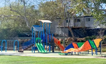 A colorful kids play structure at the park