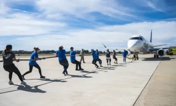 People pulling an airplane