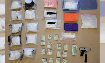 Photo from the scene, showing bags of drugs, firearms and cash.