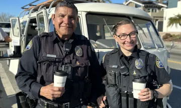 Two officers holding coffee