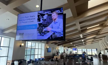 A large digital display ad inside the terminal gate area
