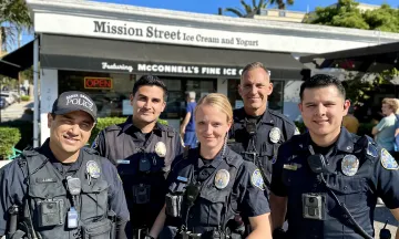 Officers Standing in front of an ice cream shop