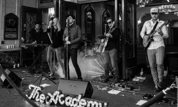 A band performing in front of a microphone