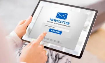 Stock image of person subscribing to newsletter on tablet.