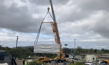 Battery storage system being installed by a crane at the Cater Water Treatment Plant