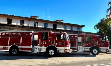 Two brand new shiny red fire engines in front of Fire Department Station 1  on carrillo street