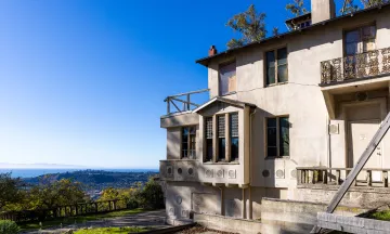 Franceschi House with view of city and ocean in the background