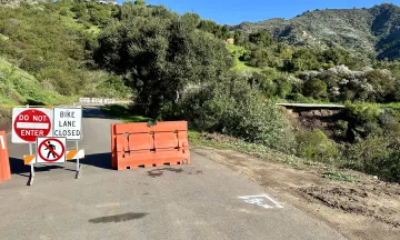 road closed signs with damaged roadway