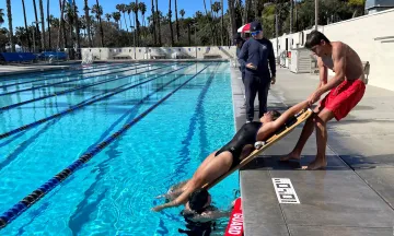 Lifeguard certification course participants practice water rescues