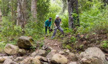 Volunteers work during a trail restoration event