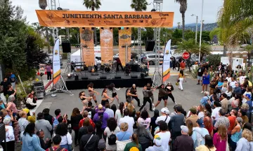 Juneteenth Santa Barbara stage with crowd gathered to watch a dance group performance.