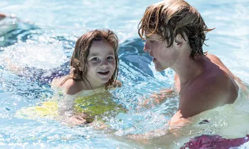 Young swimmer receives instruction from Swim Instructor at Ortega Park Pool