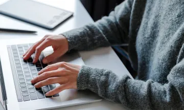 DigEplan News Item photo shows person on laptop to promote the new electronic plan review software