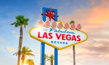 The famous sign that reads "welcome to fabulous Las Vegas, Nevada" against a sunset sky. 