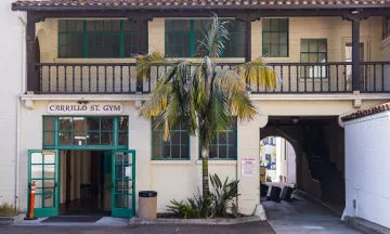 Exterior photo of the Carrillo Street Gymnasium with the front doors propped open