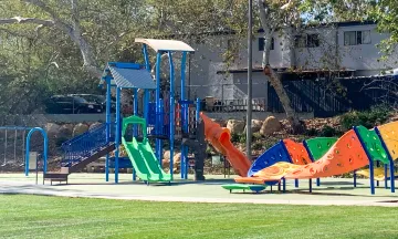 Picture shows a City Park with Playground