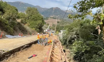 Construction crew at work building a retaining wall along State Route 192 near Parma Park.