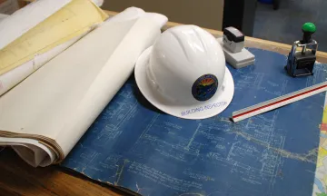 photo of plans and inspector hat