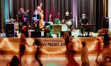 Participants swing dance to live music in the Carrillo Ballroom