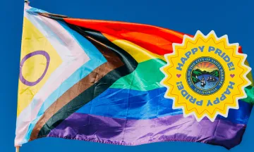 Progress Pride Flag with Happy Pride text and City seal.