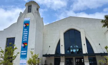SBA terminal with “Fly with Pride, Land with Love” banner.
