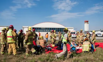 Firefighters aiding emergency drill volunteer "victims" during SBA emergency drill. 