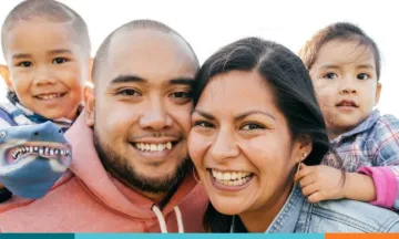 Two parents and two children smiling 