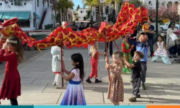 Children playing with Lunar New Year dragon