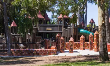 Kid’s World Playground surrounding trees.