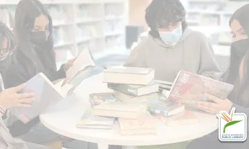 This image shows a group of teens sitting around a table engaged in a friendly discussion with the SBPL Library logo