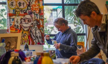 Participants painting at an activity of the Mental Wellness Center, a 2025-2026 grant recipient.
