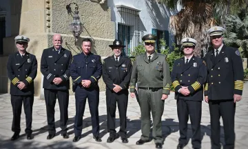 Six uniformed public safety officials pose together outside the Santa Barbara County Courthouse during the 9/11 remembrance ceremony, wearing formal dress uniforms and hats.