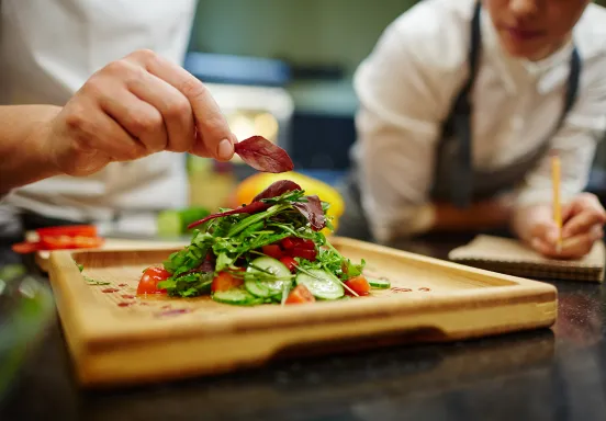 Chefs prepare a salad
