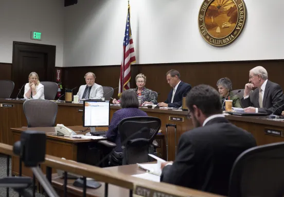 Meeting of the Planning Commission with the Seal of Santa Barbara behind them