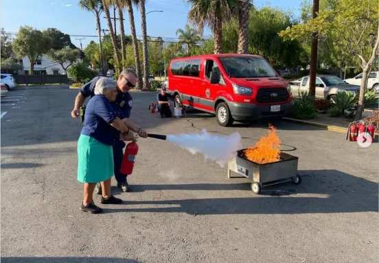 Woman practicing with fire extinguisher