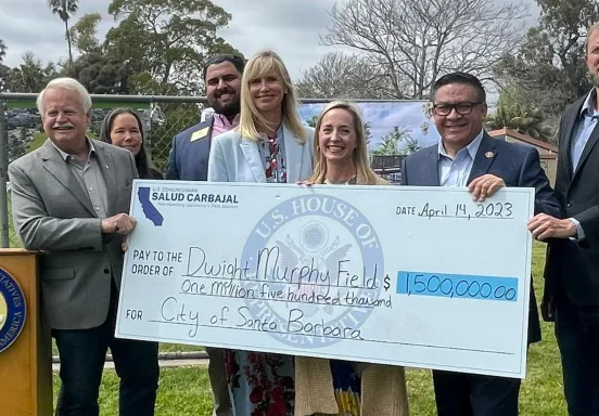 Image shows Congressman Carbajal with City officials and a large novelty check
