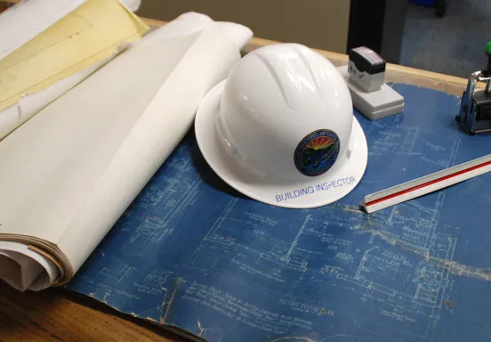 photo of plans and inspector hat