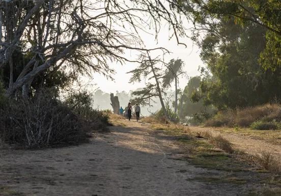 Picture of trail along Douglas Family Preserve and view of a couple on the cliffs overlooking the ocean