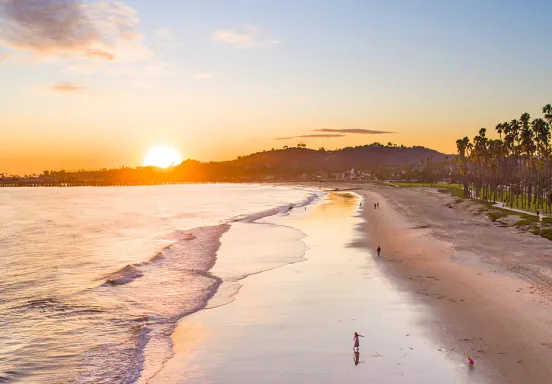 Photo of east beach at low tide view towards the sun setting over The Mesa