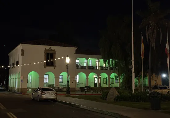 City Hall illuminated by green lights.