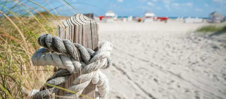 A beach with a rope tied to a post